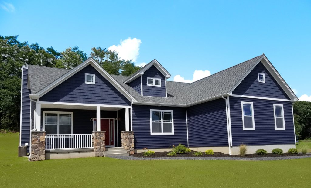 A ranch style home with blue siding 