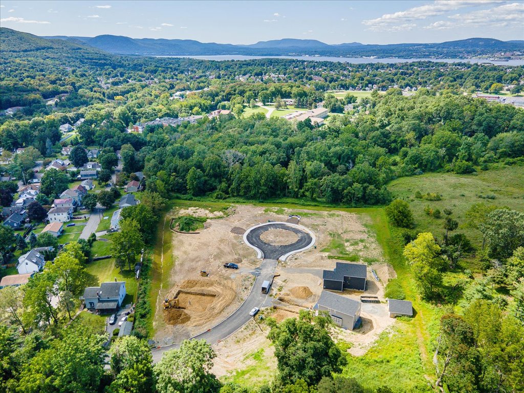 An aerial photograph of Beacon Knoll, a new home community by Rieger Homes, located in Beacon, New York, showing the proximity to the Hudson River and beautiful mountain views.