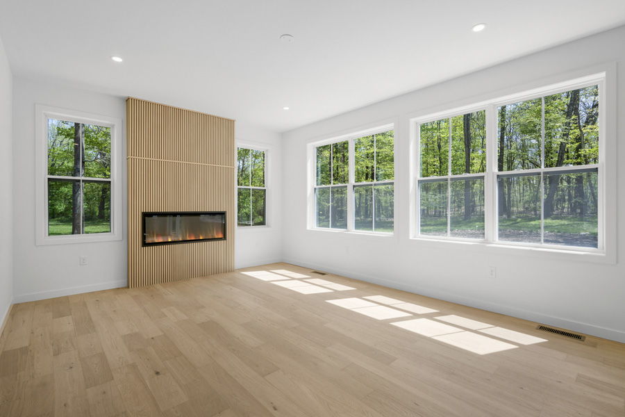 family room with fireplace and natural light on Homesite 5 at Hidden Glen in Millbrook, NY