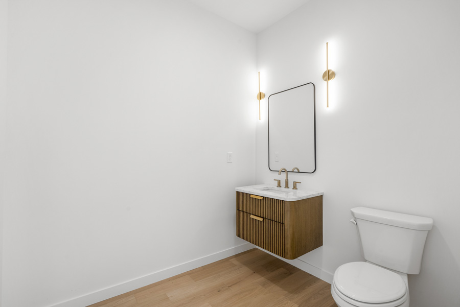 Lovely powder room with fluted floating vanity.  the Millbrook on Homesite 5 at Hidden Glen, Millbrook, NY