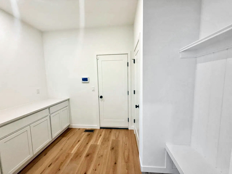 Convenient mudroom entry from garage with bench, closet and pantry storage.  The Millbrook on Homesite 5 at Hidden Glen, Millbrook, NY