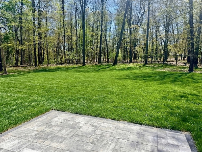 Tasteful paver patio as access to the back yard – perfect for play or entertaining.  The Millbrook on Homesite 5 at Hidden Glen, Millbrook, NY